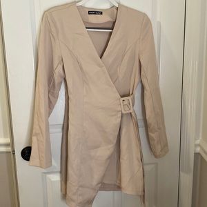 A symmetrical beige dress